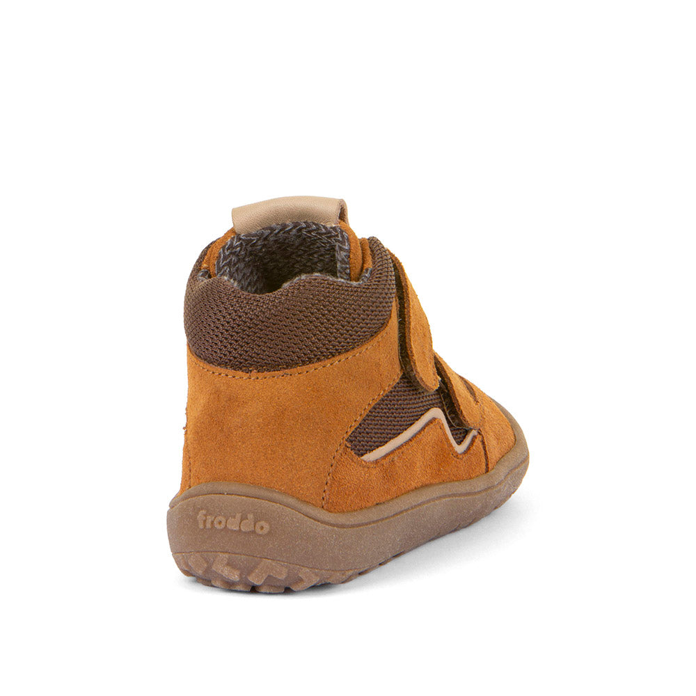 Child wearing FRODDO TEX Barfuß Knöchelschuh G3110254-14 in cognac and brown, playing outdoors