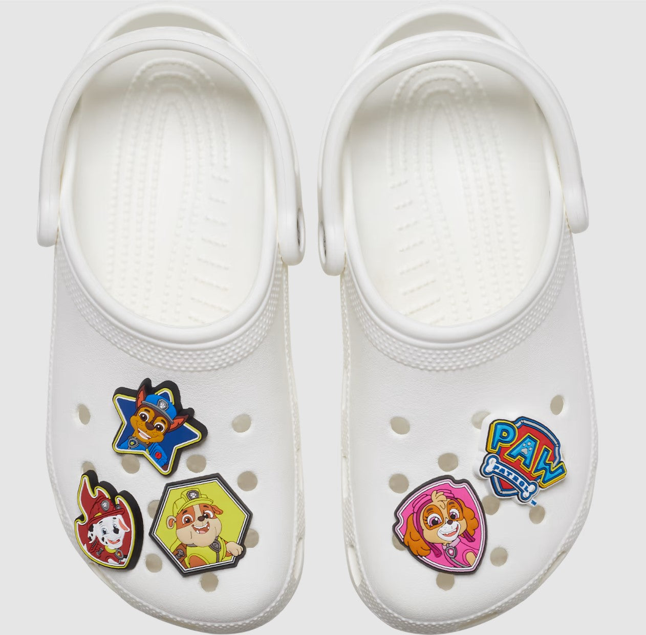 Alt text: Colorful CROCS Jibbitz featuring Paw Patrol character Chase, perfect for kids