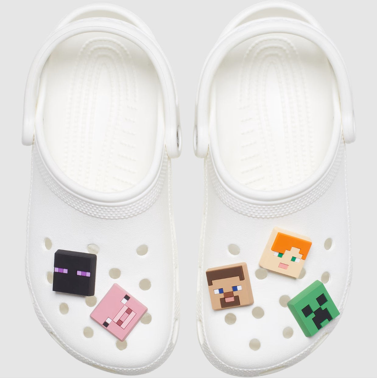 Pair of black CROCS Jibbitz featuring Minecraft-themed designs