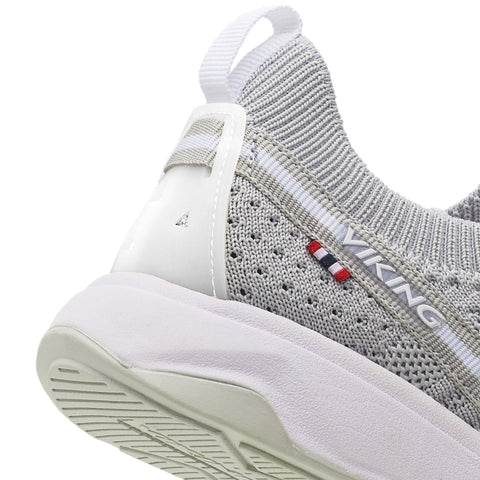 Pair of VIKING Halbschuh ENGVIK - hellgrau displayed on a rocky terrain, highlighting the slip-resistant outsole