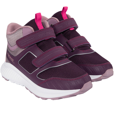 Woman wearing the Viking Gore-Tex Knöchelschuh AERY MID WP 2V - aubergine hiking boot while trekking through muddy terrain