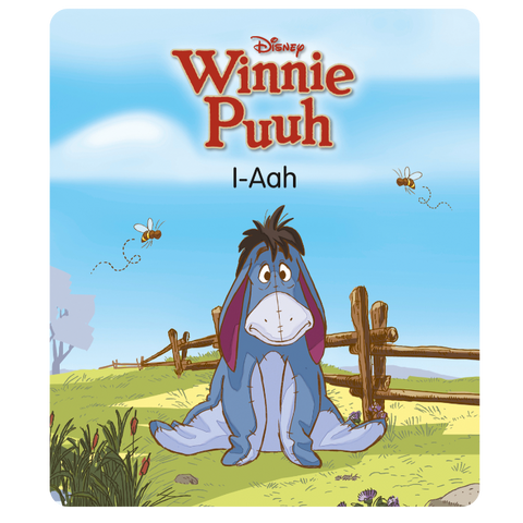Tonies Figur Winnie Puuh I-Aah, blauer Esel vor grünem Feld mit Holzzaun und Bienen.