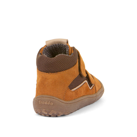Child wearing FRODDO TEX Barfuß Knöchelschuh G3110254-14 in cognac and brown, playing outdoors