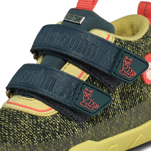 Seitenansicht des AFFENZAHN Sneaker KNIT HAPPY RAUPE in petrol/neongrün mit Klettverschluss und rotes Ant-Logo.