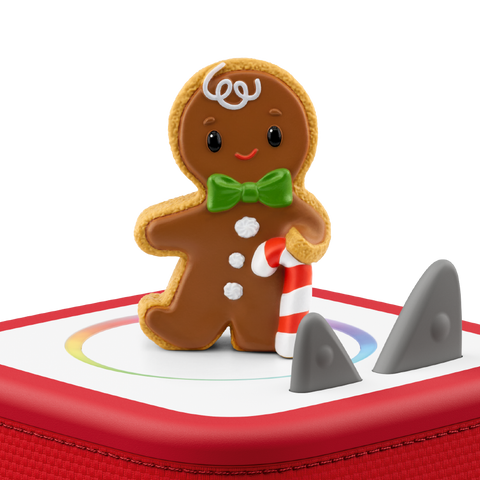 Vorderansicht der TONIES Figur: brauner Lebkuchenmann mit grüner Schleife, Zuckerstange vor roter Fläche.