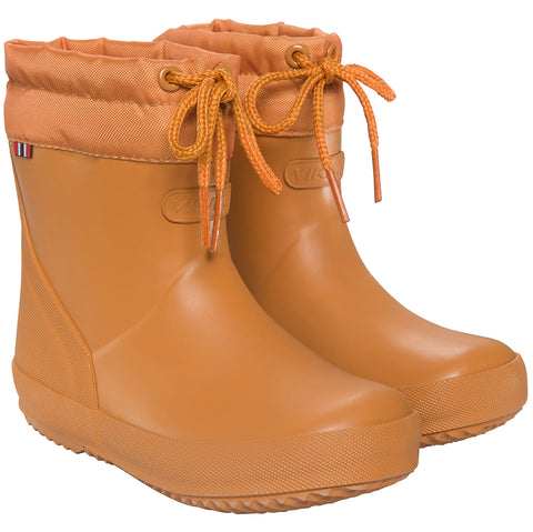 A close-up image of the VIKING Gummistiefel ALV INDIE WARM in curry color, showcasing the durable rubber material and cozy warm lining for cold weather