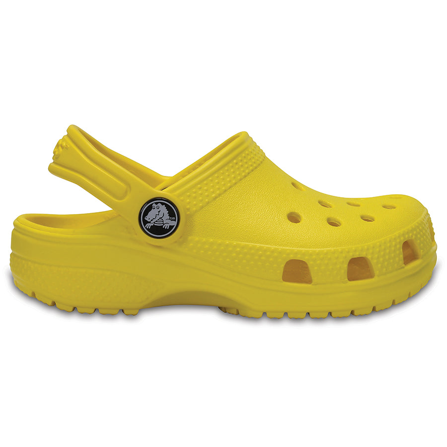 A pair of bright yellow CROCS CLASSIC KIDS shoes, perfect for active children