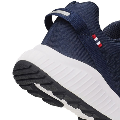 Outdoor lifestyle image of a person wearing the VIKING GORE-TEX Halbschuh AERY TAU LOW GTX - navy shoe while hiking in rugged terrain