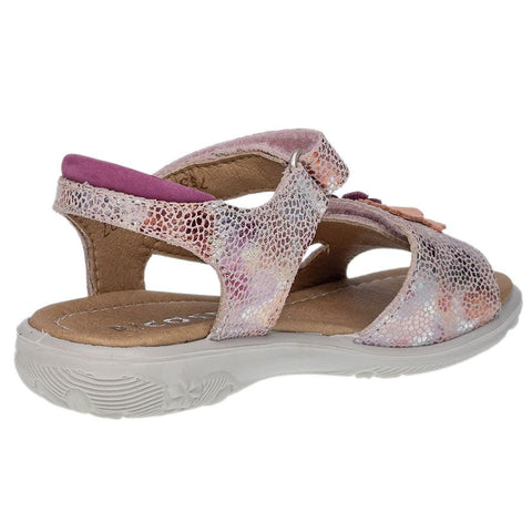 Young girl wearing RICOSTA Sandale CILLA - rosé - beere, walking on a sandy beach, enjoying the comfort and support
