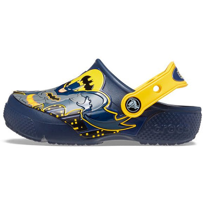 Person wearing CROCS BATMAN PATCH CLOG 207470-410 - navy shoes walking on pavement