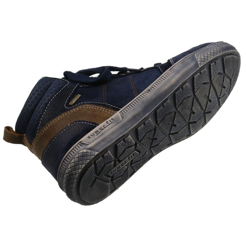 Person wearing SUPERFIT GORE-TEX Knöchelschuh 201-80 in navy and brown while hiking on a trail