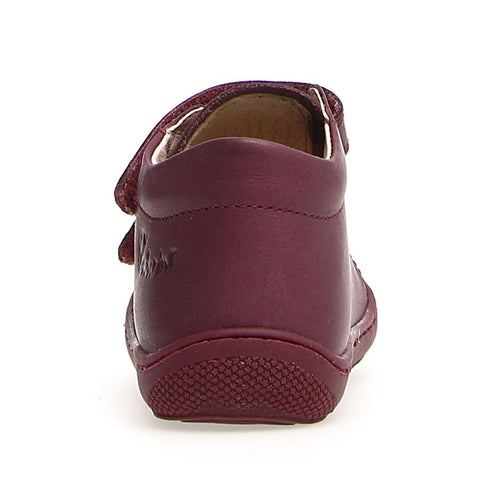 Pair of NATURINO Halbschuh COCOON - magnolia - magnolia shoes next to colorful flowers, emphasizing their vibrant design and playful aesthetic