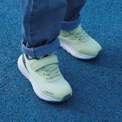 Woman wearing the VIKING Halbschuh AERY DAL LOW - mint - petrol outdoor shoe on a nature trail